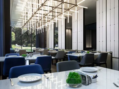 A modern restaurant interior with marble tables and chairs, featuring a minimalist design with sleek, clean lines.