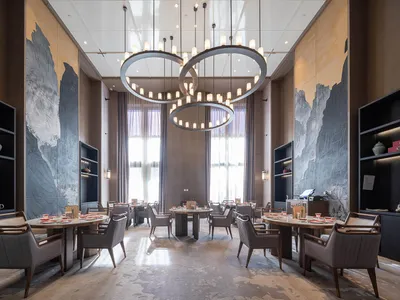 Modern, luxurious dining room with contemporary wood, metal, and textured floor.
