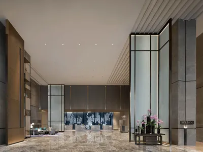 Modern hotel lobby featuring marble, glass, and metal materials and design.