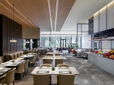 A modern restaurant interior featuring marble countertops, wooden paneling, and leather seating.