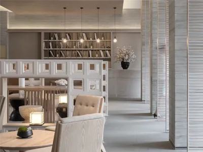 Modern minimalist restaurant interior featuring concrete flooring, wooden furniture, and glass accents.