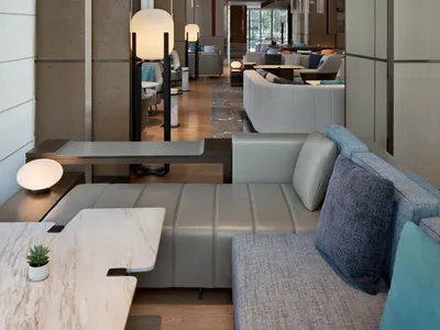 Modern hotel lobby with neutral tones and minimalist design.