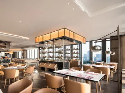 Modern restaurant interior with minimalist design, featuring contemporary fixtures and furniture.