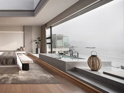 Modern, minimalist bedroom featuring concrete elements, large window, and indoor plants.