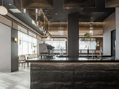 An elegant minimalist restaurant bar with metal accents and a stone counter, featuring industrial lights and modern design el