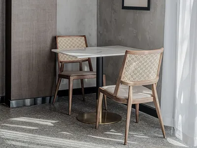 Modern commercial design featuring a restaurant table setting with a contemporary table and chairs, designed with minimalist
