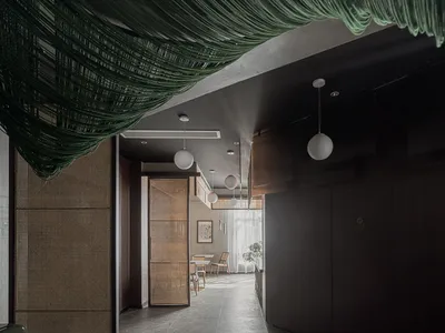 Contemporary restaurant interior with greenery accent and wooden decorative panels.