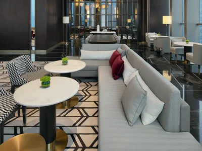 A modern hotel lobby with marble flooring and contemporary seating arrangements.
