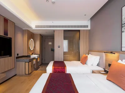 Modern hotel room featuring wooden furniture with minimalist decor.