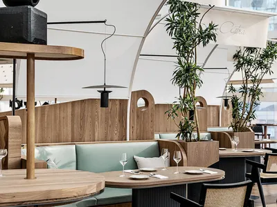 Modern restaurant interior with wooden furniture and leather accents