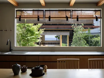 A contemporary kitchen with wooden cabinets and metallic accents.