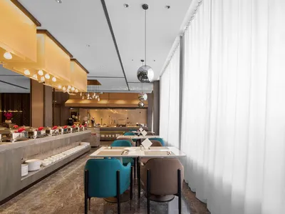 Modern restaurant interior with marble and concrete finishes, showcasing contemporary design elements.