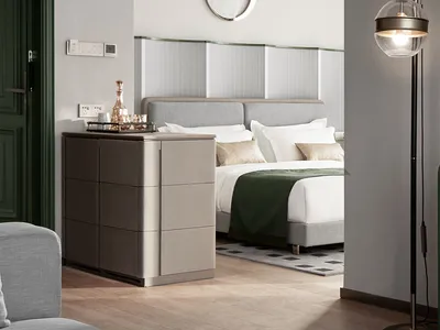 Modern bedroom featuring minimalist furniture, white walls, and a stylish headboard.