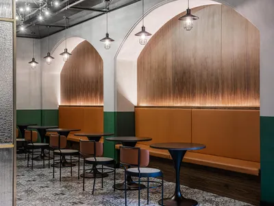 Modern cafe interior with booth seating featuring wooden accents and leather upholstery