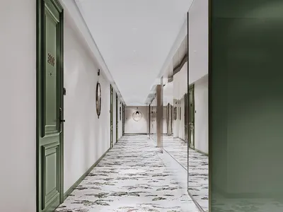 A modern hotel corridor with patterned floor tiles and green doors.