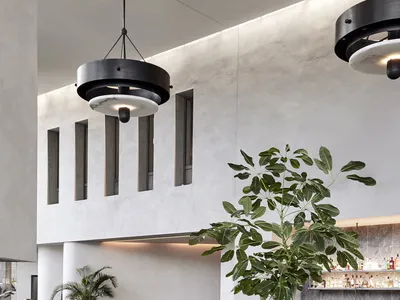 Modern restaurant interior with concrete, marble, and wooden finishes.