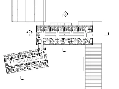 Floor plan of a hotel on the fourth floor, showing guest rooms and suites, a lobby, and an atrium.