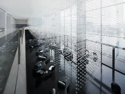 A modern hotel lobby featuring glass and concrete materials.
