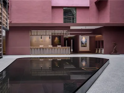 Modern reception lobby with a concrete design featuring sleek lines and minimalist architecture.