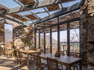 A cozy coffee shop with a glass rooftop and stone walls