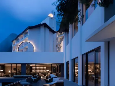 Modern hotel lobby featuring glass walls and a circular window