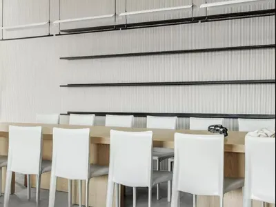 Modern restaurant interior with white leather chairs and wooden tables
