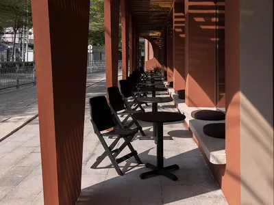 Outdoor seating area with wooden tables and chairs at a restaurant