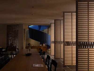 A modern restaurant interior with concrete, glass, and wood materials and furniture.