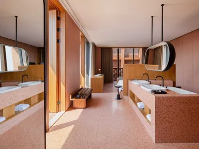 A modern hotel room featuring a terrazzo interior design with a minimalist and contemporary aesthetic.