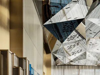Modern hotel lobby featuring glass, metal, and marble materials