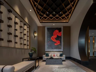 A modern hotel lobby with marble and concrete finishes, showcasing contemporary design elements.