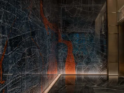 A sleek, contemporary hotel lobby featuring elegant marble design elements.