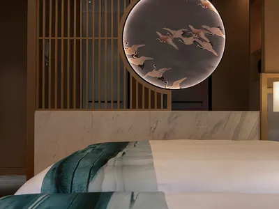 Modern minimalist bedroom with a bed featuring a fabric headboard placed against a marble and wooden wall with a circular dec