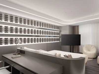 A sleek, modern hotel room featuring metallic finishes and a minimalist design.