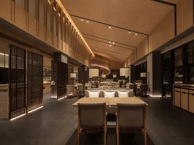 Modern restaurant interior with concrete, metal, and glass materials.