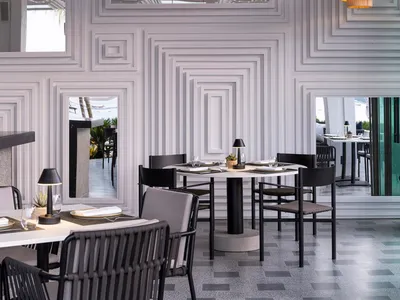 A modern restaurant featuring geometric concrete structures and minimalist design.