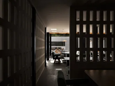 A modern restaurant interior with wooden furniture and a spacious seating area.