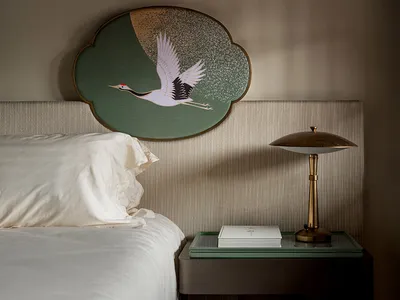 A modern bedroom featuring an intricate crane headboard
