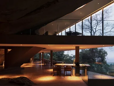 A modern restaurant interior with a concrete floor and open design.