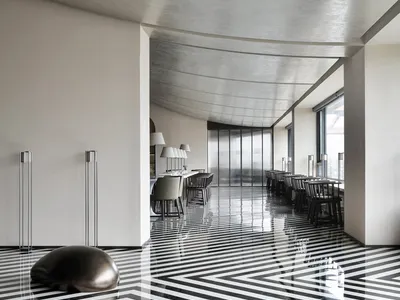 A modern restaurant interior with a striking black and white tiled floor.