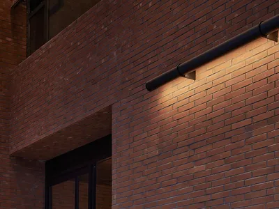 Exterior of a restaurant with red brick walls and a glass door.
