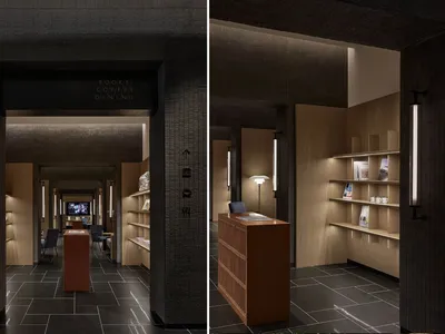 A modern restaurant featuring wooden shelves and black tiles on the floor.