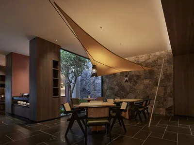 Industrial-style restaurant interior with concrete and wooden elements.