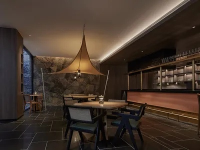 A modern restaurant bar with mixed materials and contemporary design.