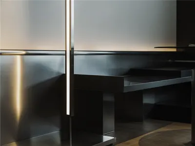 Modern restaurant interior featuring metallic seating and sleek, minimalist design.