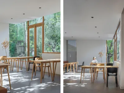 A modern restaurant interior featuring wood and glass materials.