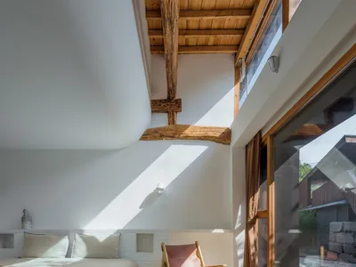 Modern minimalist bedroom featuring wood, concrete, and glass materials.