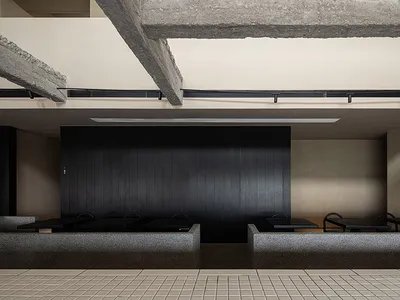 Modern industrial restaurant interior with concrete walls and seating