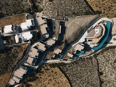 Aerial view of a modern resort with concrete and glass structures.