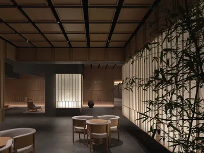A minimalist restaurant interior with dark wood accents and delicate lighting